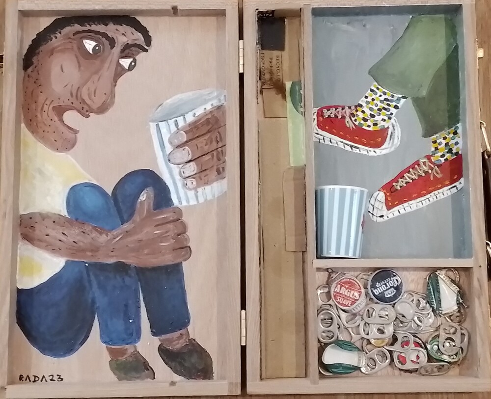 <b>Borrachito</b><br>Técnica: Técnica mixta, acrilico, objetos varios, en una caja de madera<br>Dimensiones: 36x30cm<br>Año: 2023